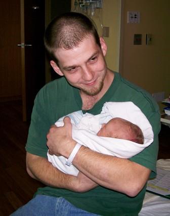Mark holding newborn son Brennan